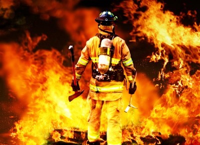 Colour photograph showing a firefighter at the scene of a fire